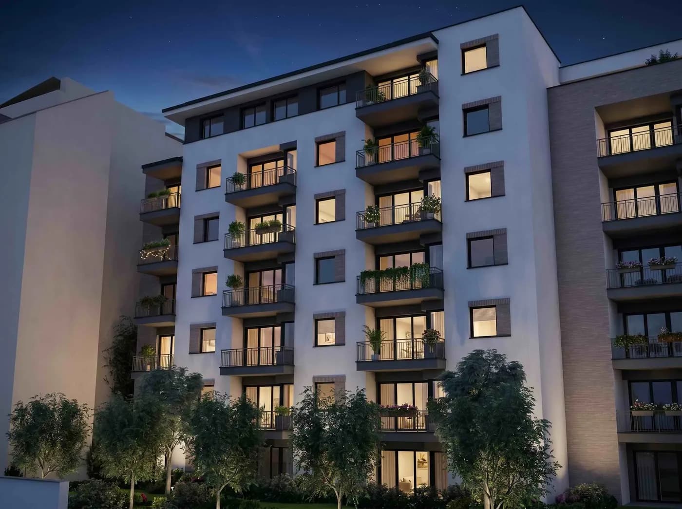 A NOVA City Residence homlokzata esti fényben, világító ablakokkal
